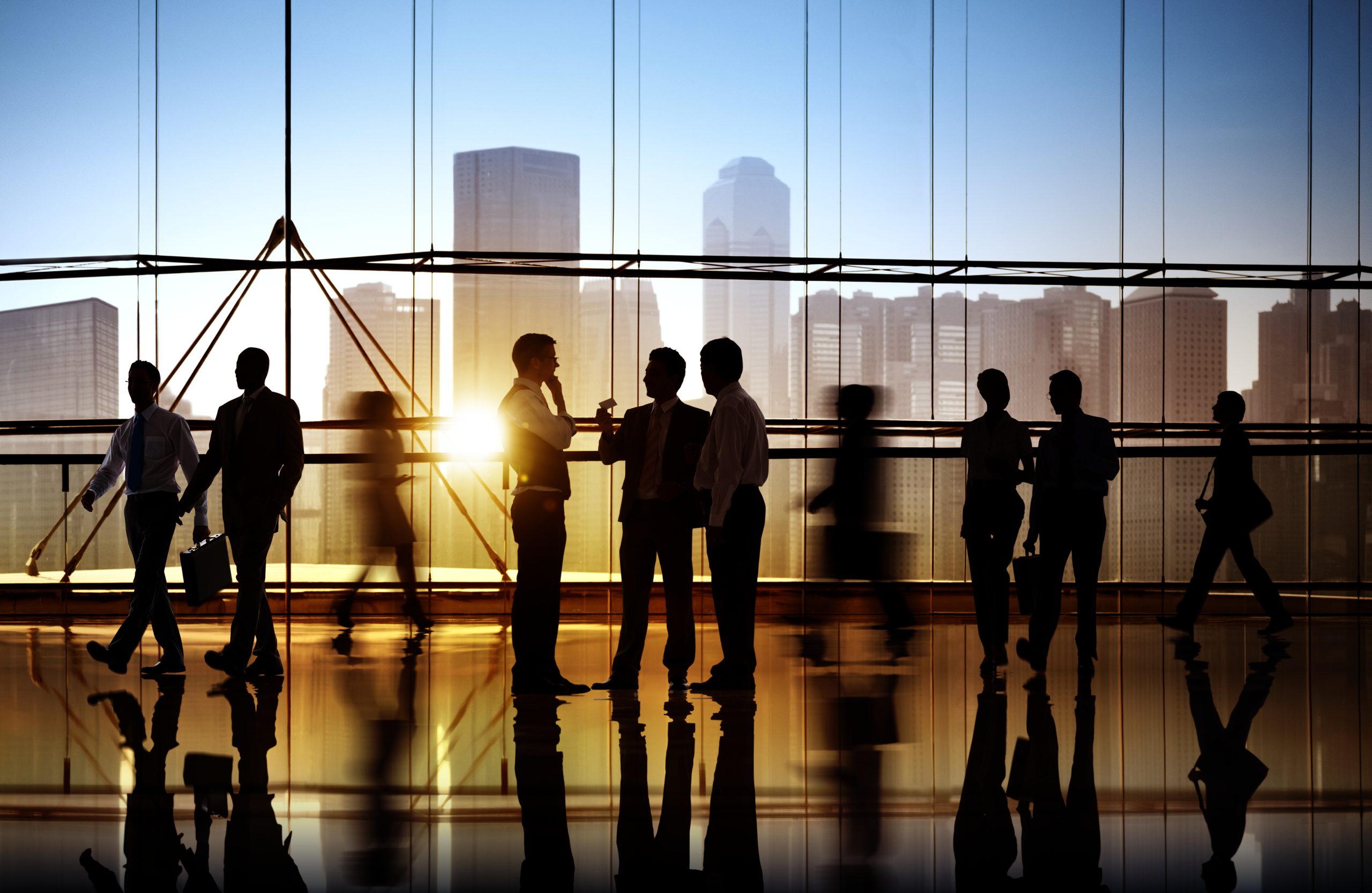 Business professionals moving through a modern corporate environment